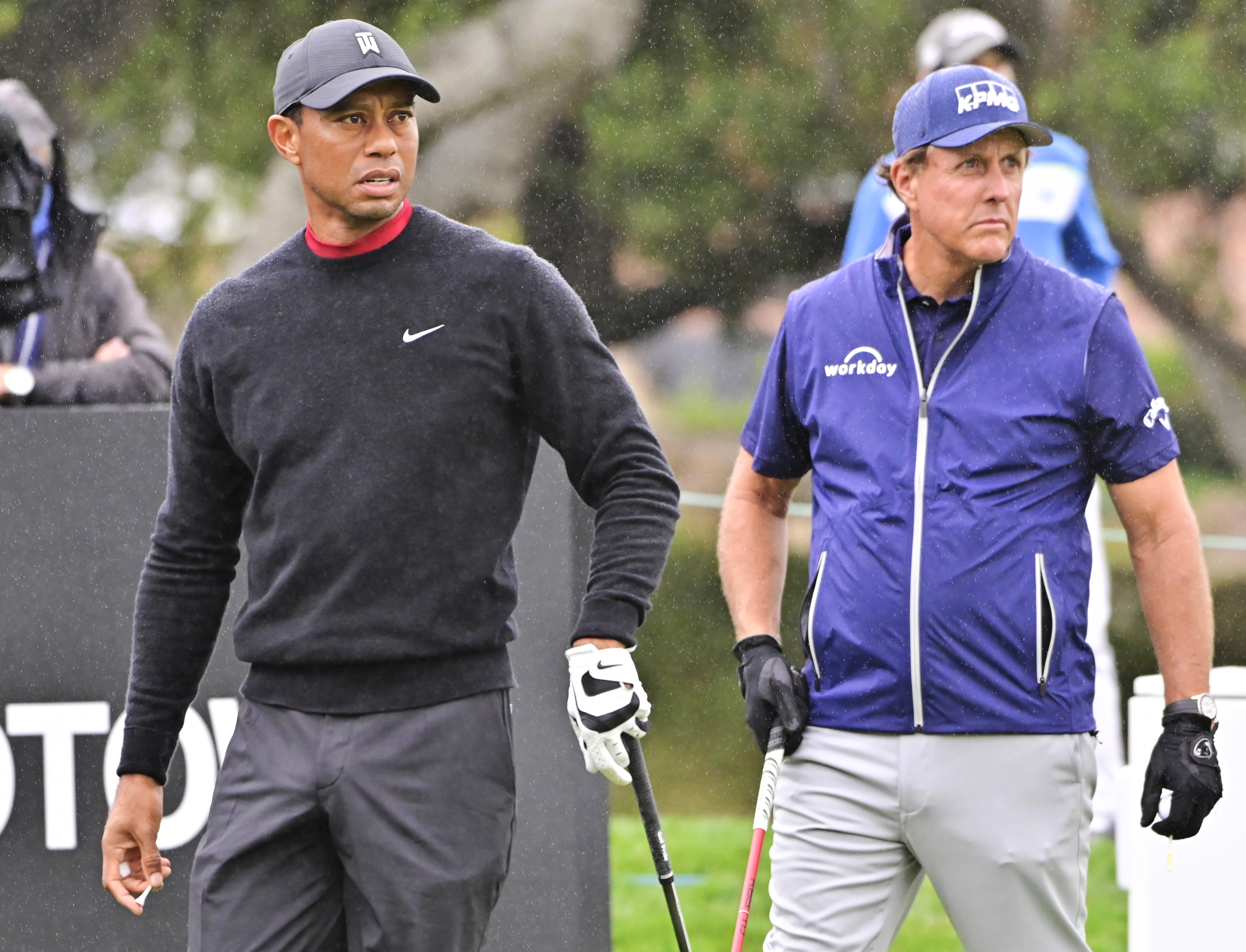 Tiger Woods watches his tee shot on 10 while Phil Mickelson gets ready to hit during the final round of the ZOZO Championship at Sherwood Country Club
