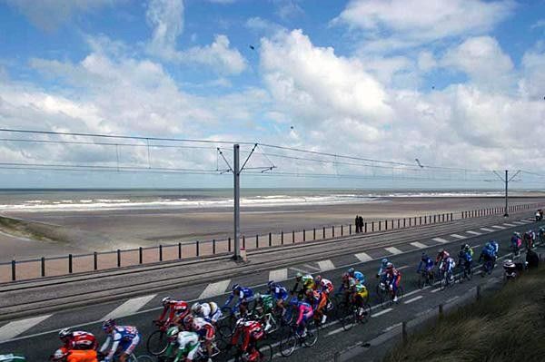 The peloton rides along the west coast of Belgium