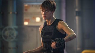 Still from a Terminator movie. A muscular lady with short, cropped hair wearing a black bulletproof vest. She had a big, thick black chain wrapped around her hand, ready to fight.
