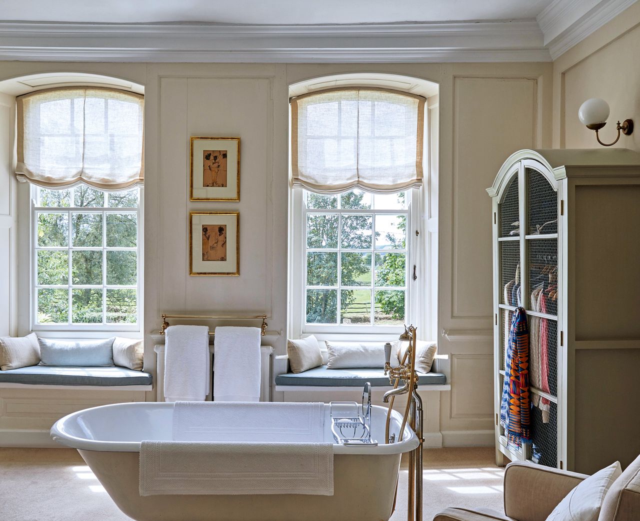 A bathroom with blinds, as designed by Todhunter Earle.