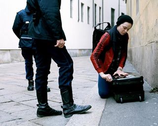 Dror For Tumi Milan - woman closing her bag on the pavement