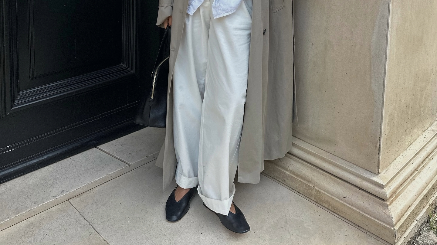 Debora Rosa in a trench coat and Le Monde Beryl flats.