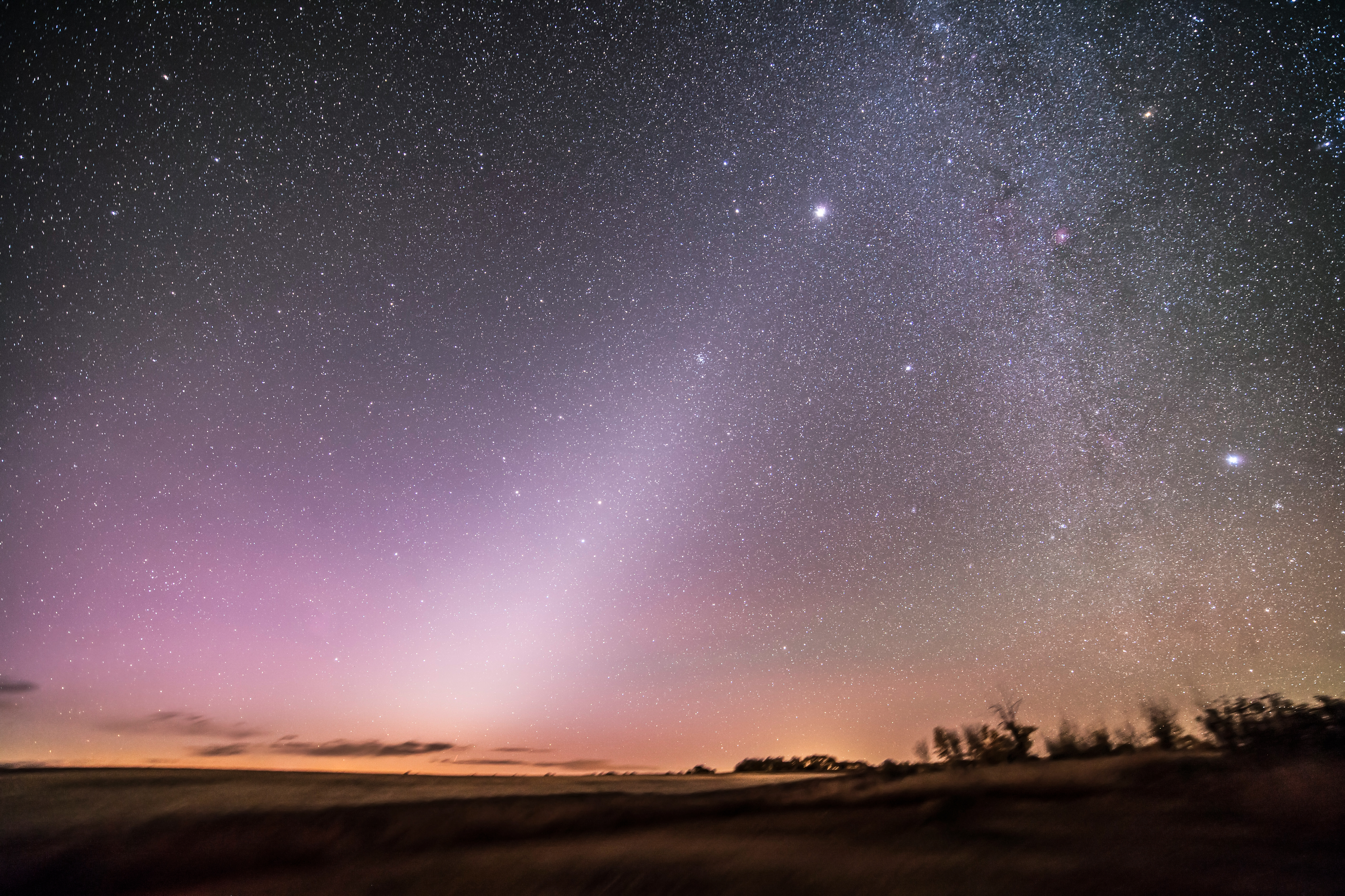 The zodiacal light in the pre-dawn sky in Alberta, Canada. Leo is just rising left of centre, with Mars above Regulus. Jupiter in Gemini is the bright object above centre. Sirius at at far right. At centre is the Beehive Cluster, M44.