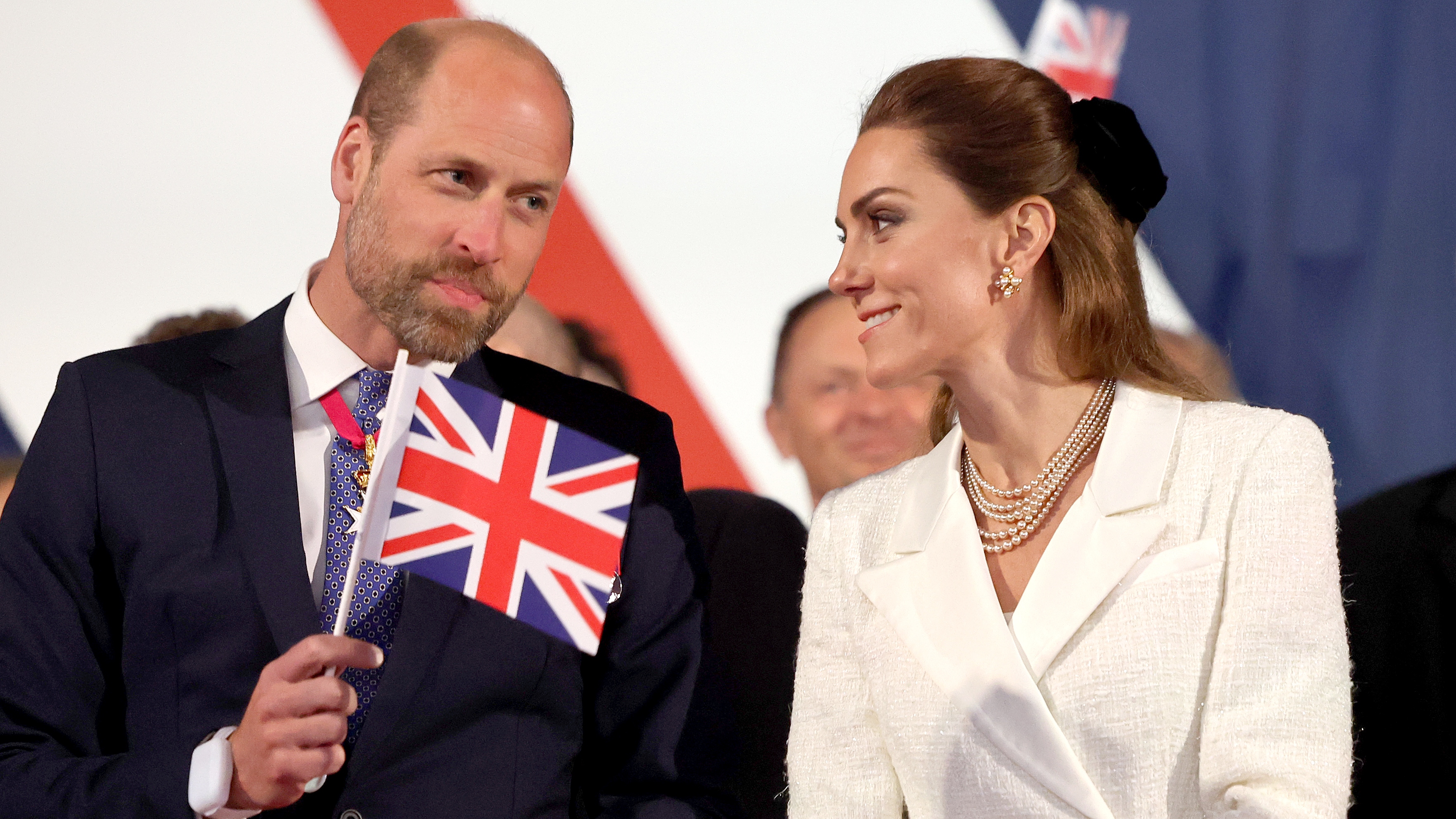 Prince William, and Catherine, Princess of Wales look at each other as they attend a concert to mark the 80th Anniversary of VE Day at Horse Guards Parade on May 08, 2025