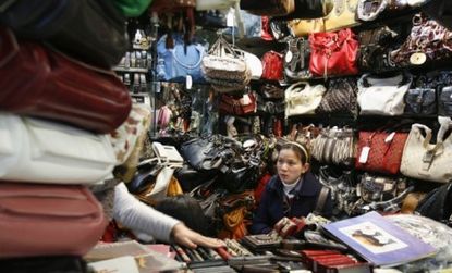 A counterfeit bag stall in Beijing: Fake designer bags may help sales of the pricier originals they copy, according to new research.