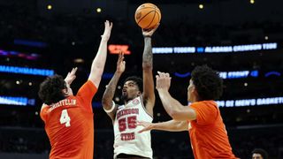 Aaron Estrada #55 of the Alabama Crimson Tide shoots the ball against Ian Schieffelin #4 of the Clemson Tigers during the first half in the Elite 8 round of the NCAA Men's Basketball Tournament 