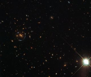 This NASA/ESA Hubble Space Telescope image shows remarkable structures in a galaxy cluster around an object called LRG-4-606.