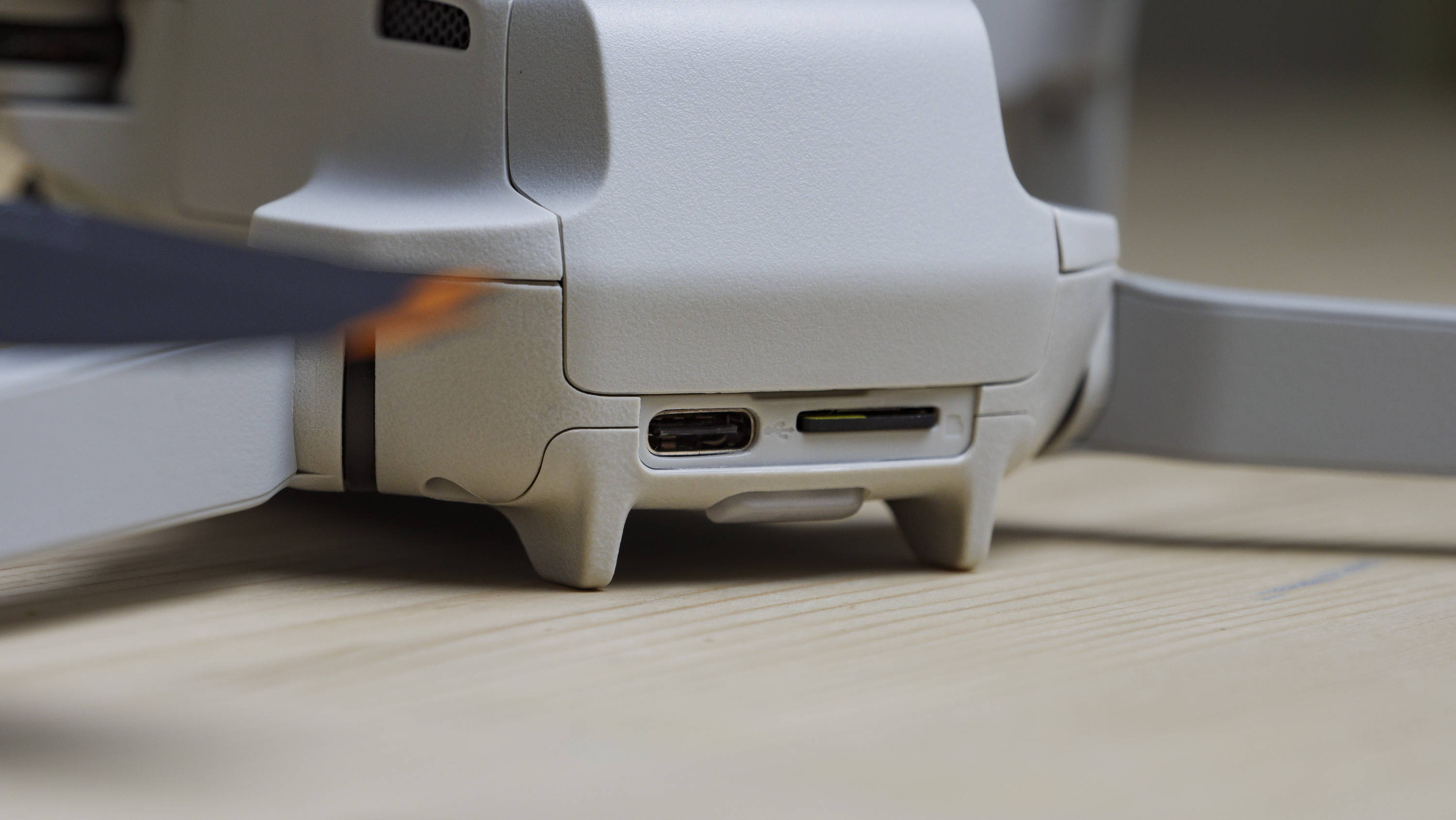 Closeup of the DJI Mini 4K beginner drone's USB-C and memory card ports