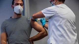  A medical worker administers an injection to a volunteer during a phase 3 trial of the Johnson & Johnson COVID-19 vaccine.