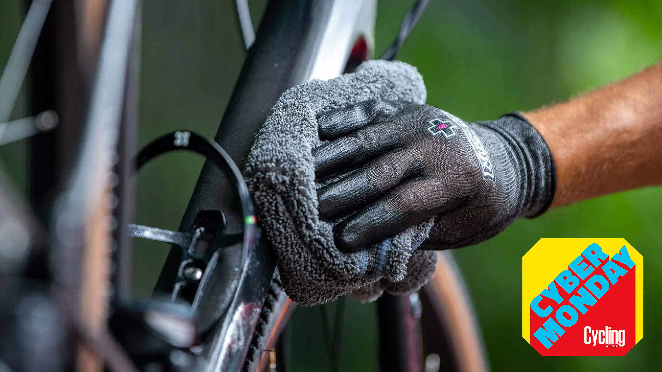 cyclist whipping down a bike wearing muc off gloves with a Muc-off towel. 
