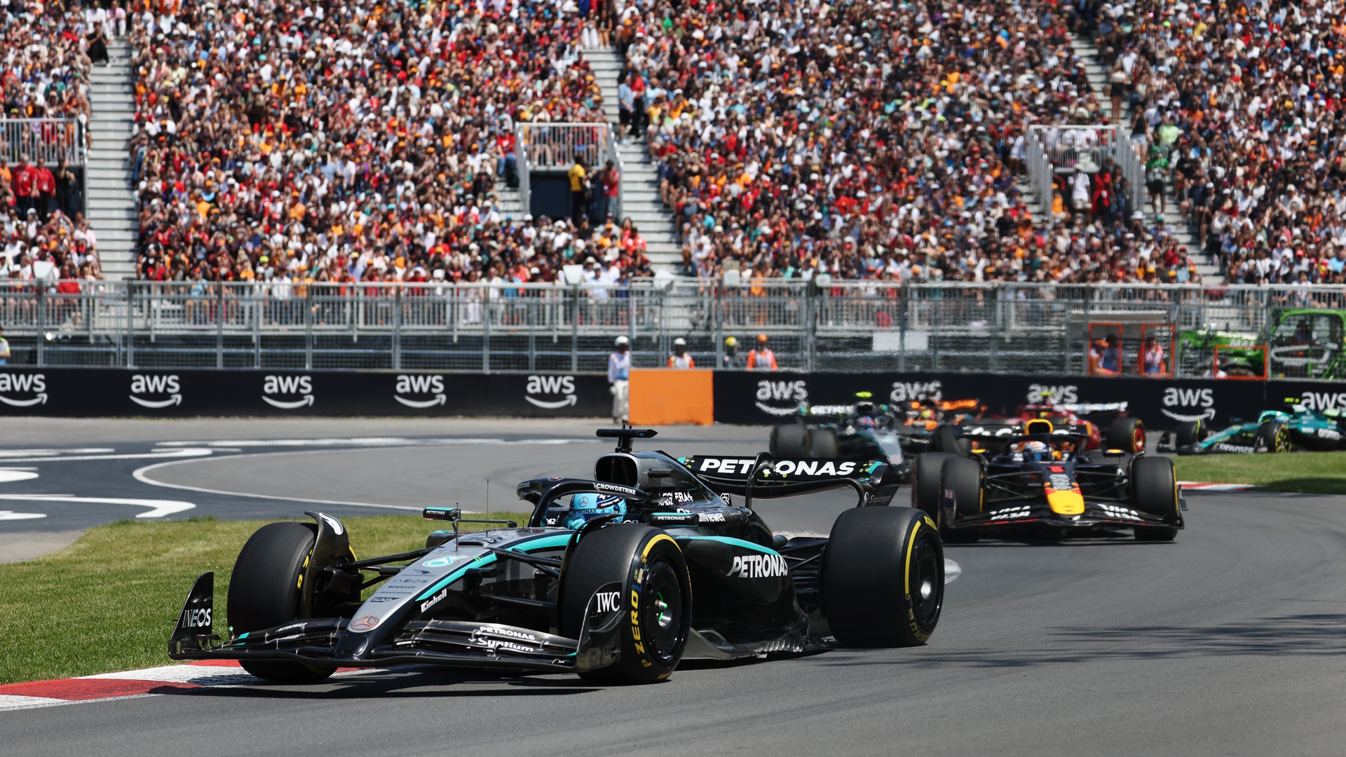 George Russell of Mercedes driving ahead of Max Verstappen of Red Bull and Kimi Antonelli of Mercedes during the F1 Grand Prix of Canada.