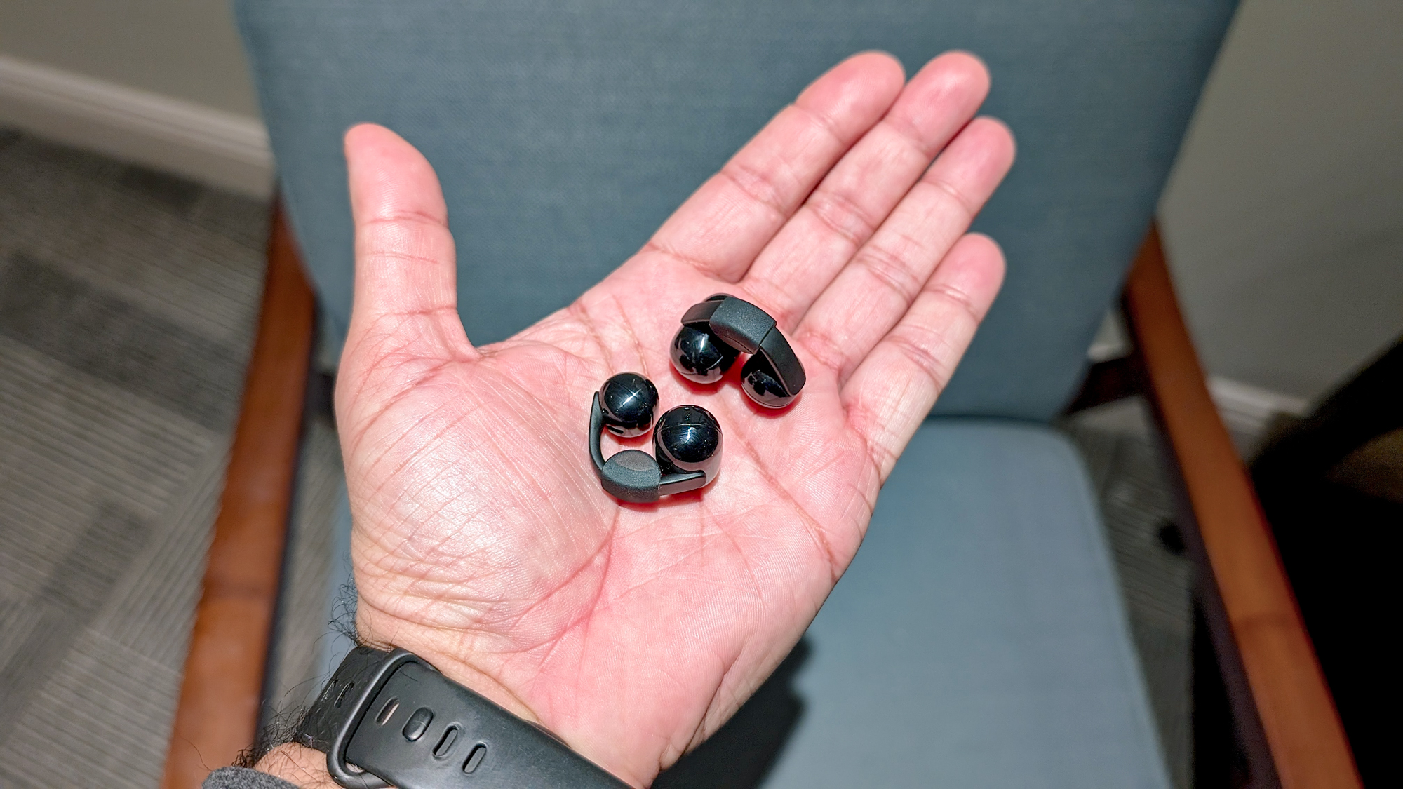 The Sony LinkBuds Clip in a Tom's Guide reviewer's hands and ears.