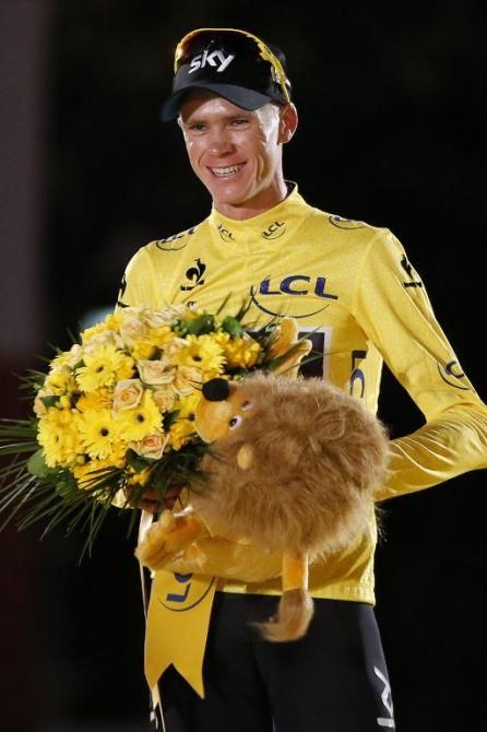 Christopher Froome with the spoils of victory on the podium in Paris after the 100th Tour de France