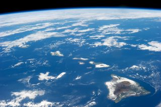 Hawaii is seen from space, all alone in a big ocean.