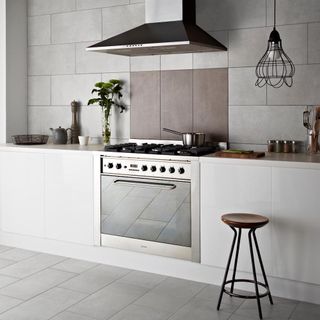 kitchen room with kitchen chimney and white tiled flooring
