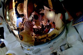 Kelly snaps one of the coolest selfies ever taken — himself suited up for a spacewalk.