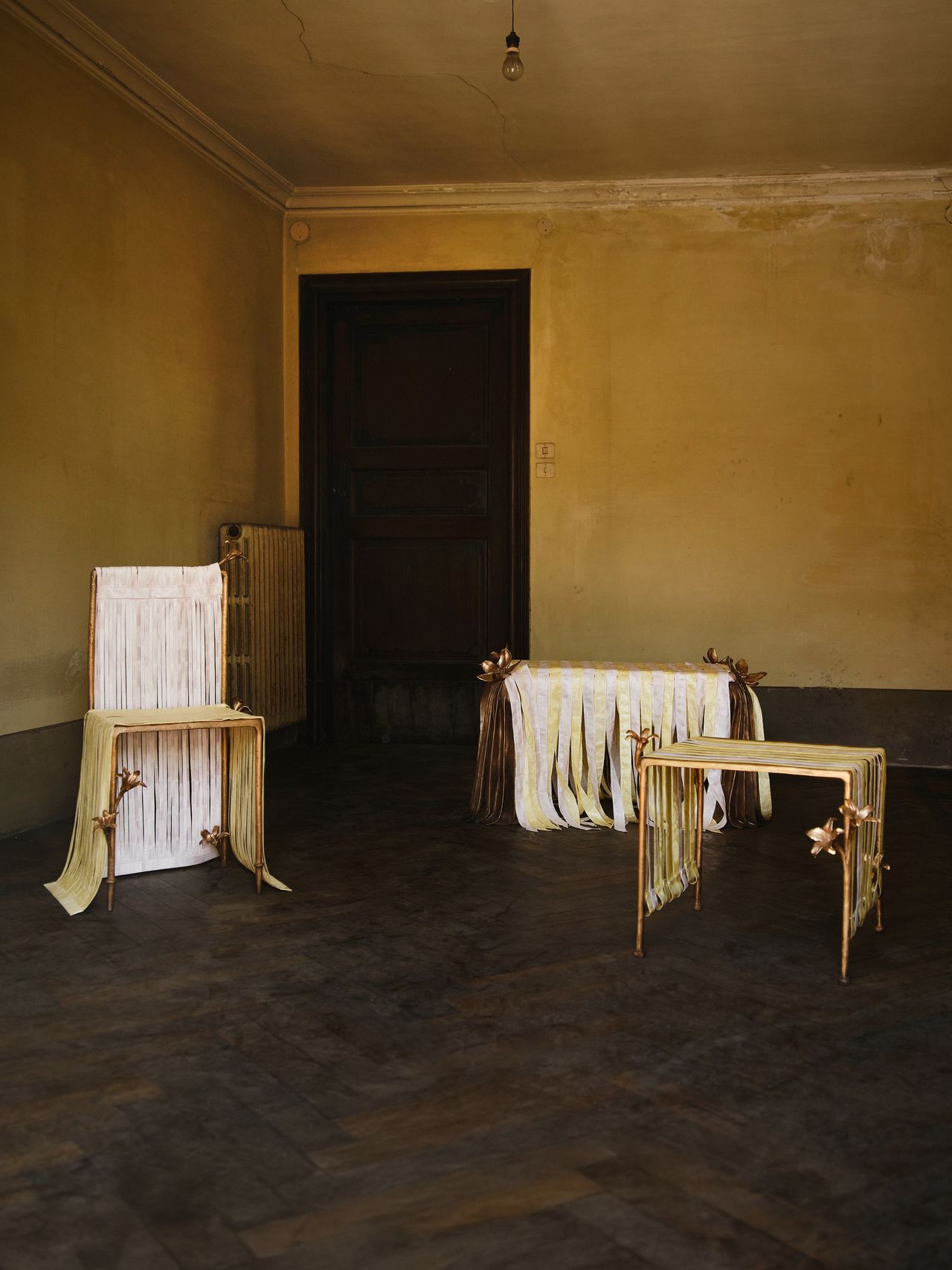 bronze furniture draped in pastel ribbons