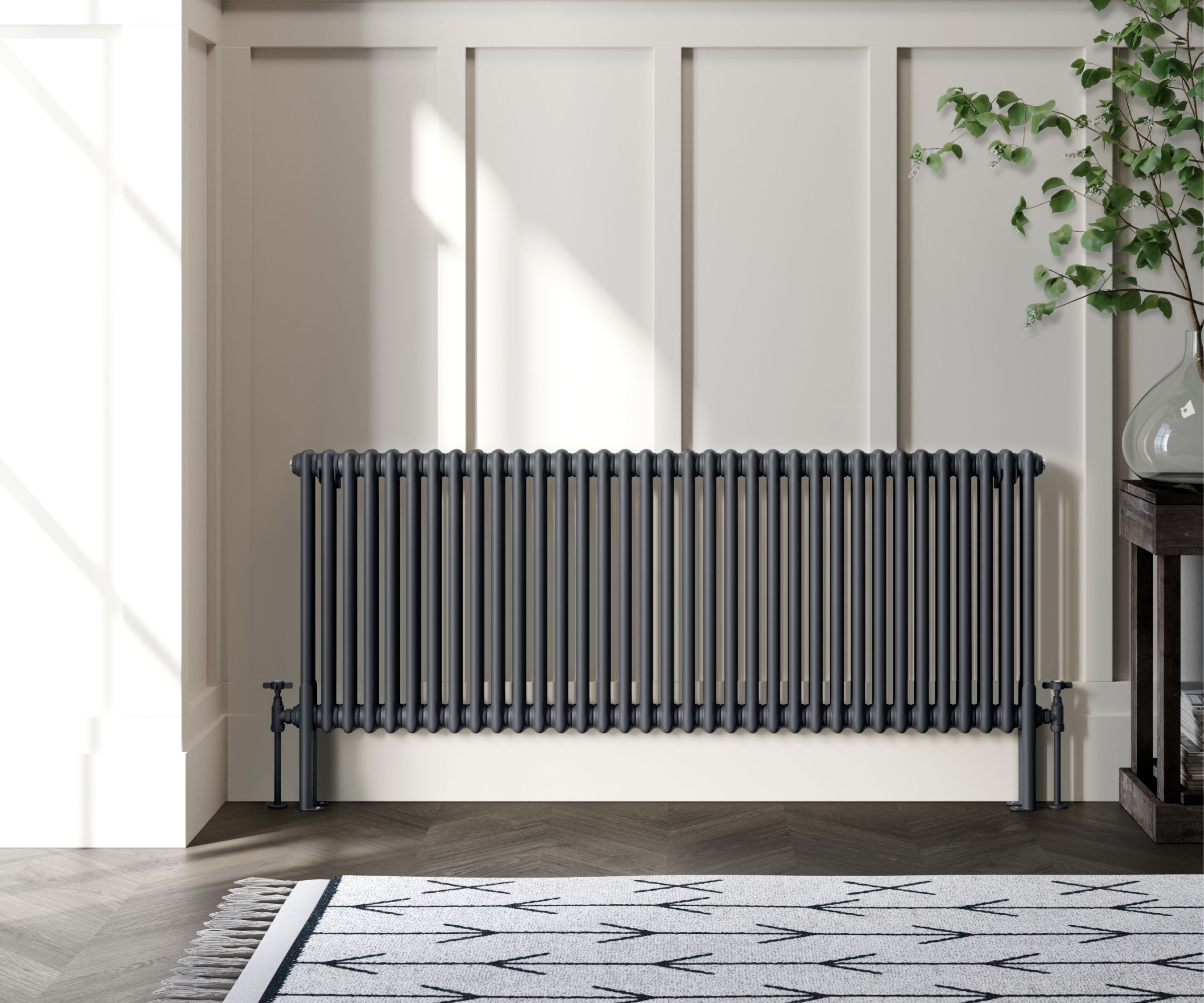 A grey traditional style radiator in a hallway