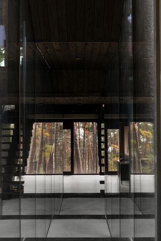 interior with large window towards trees at Villa Nikkesmelle by Gartnerfuglen