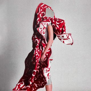 Woman in red Byredo blanket