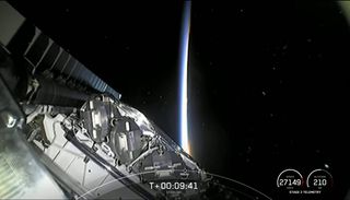 This view from a SpaceX Falcon 9 upper stage shows the stack of 52 Starlink satellites launched into orbit on Dec. 18, 2021 as dawn breaks.