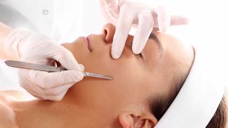 Woman having dermaplaning treatment in a clinic