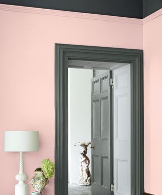 Corner of living room, light pink painted walls, dark gray trims