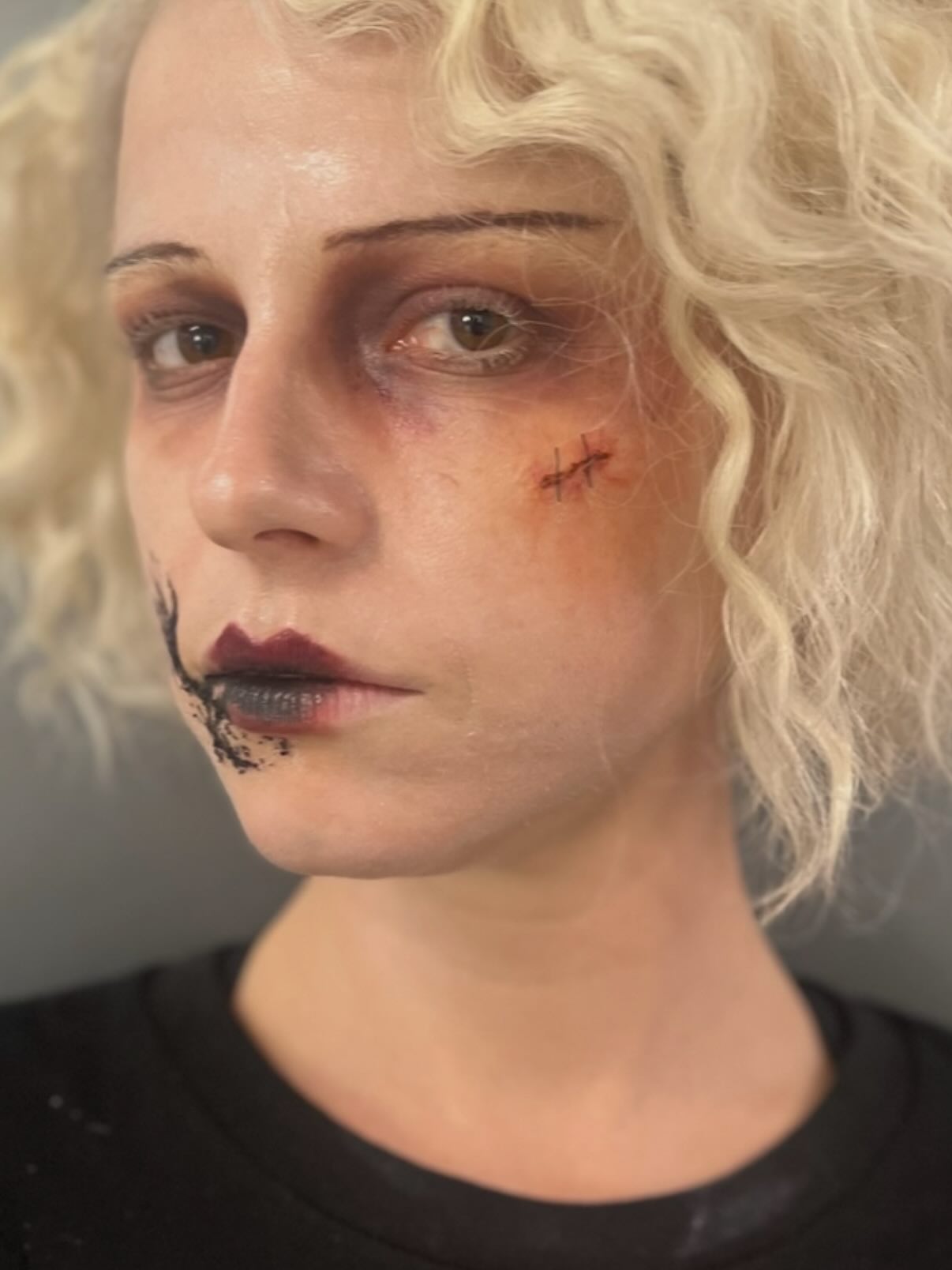 An image of Jessie Buckley in hair and makeup on the set of The Bride!