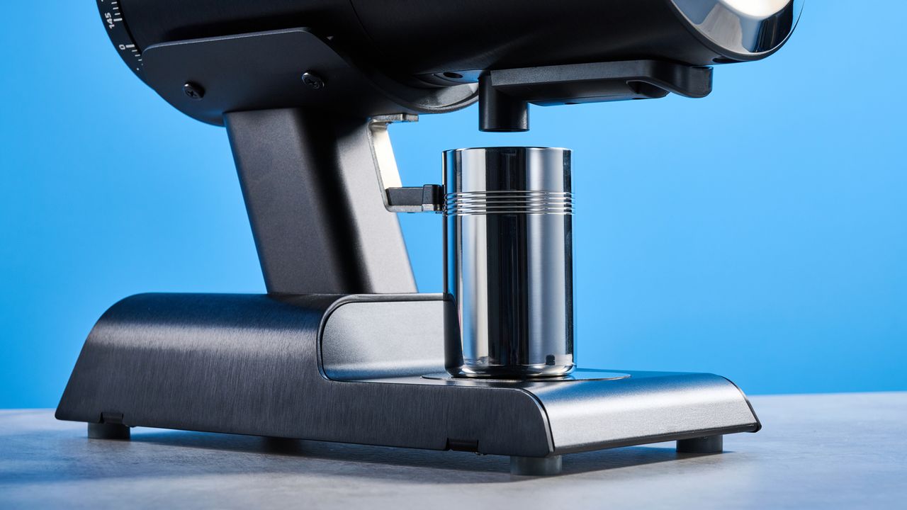 the mazzer philos coffee grinder in black and stainless steel photographed against a tom's guide blue background