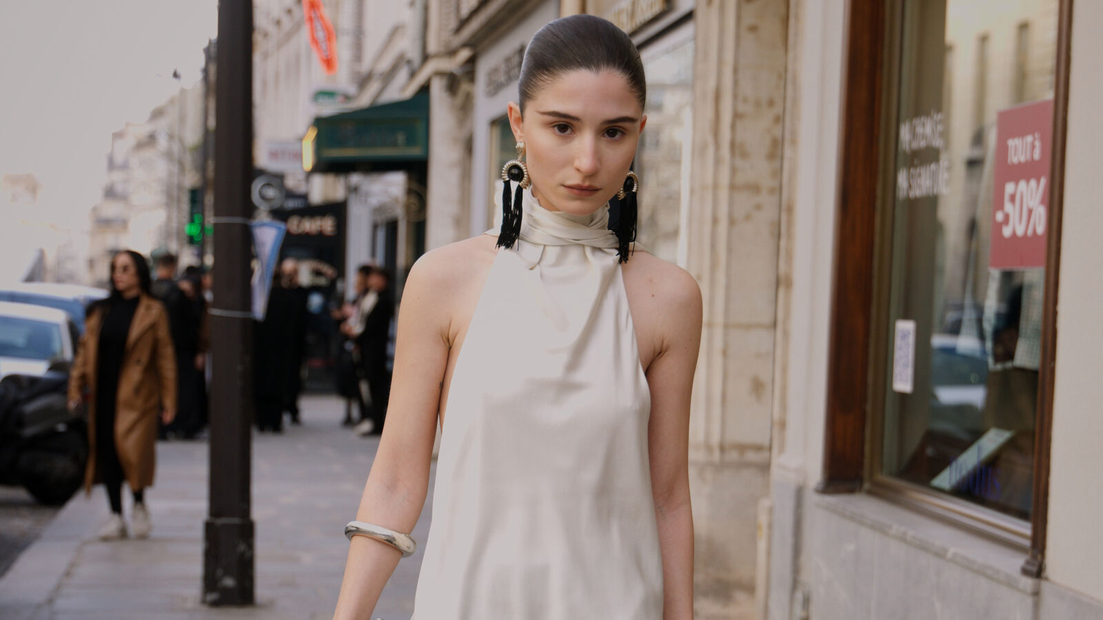 Woman in Paris wearing a white silk top.
