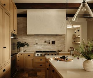 A plastered range hood in a transitional kitchen