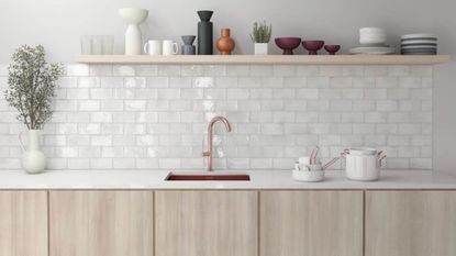 A pink kitchen with a glossy white tiled backsplash