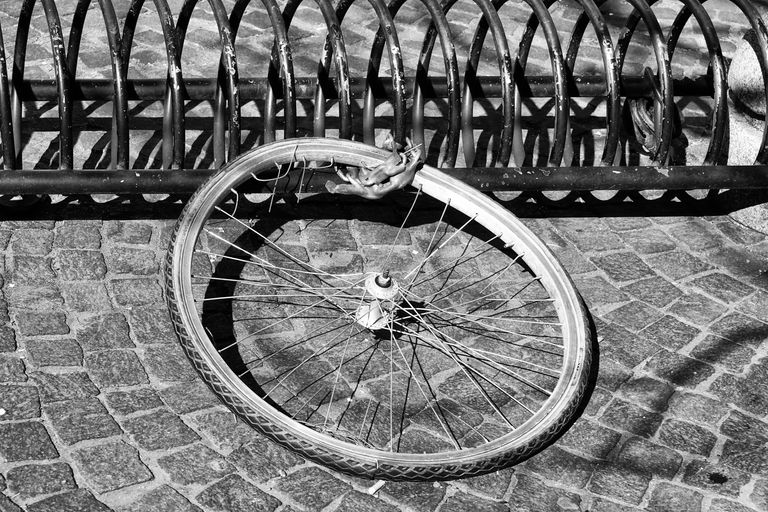 The image of just wheel locked to a bike stand shows the importance of having the best bicycle insurance 