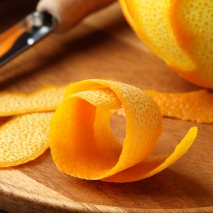 orange peel on kitchen table with knife