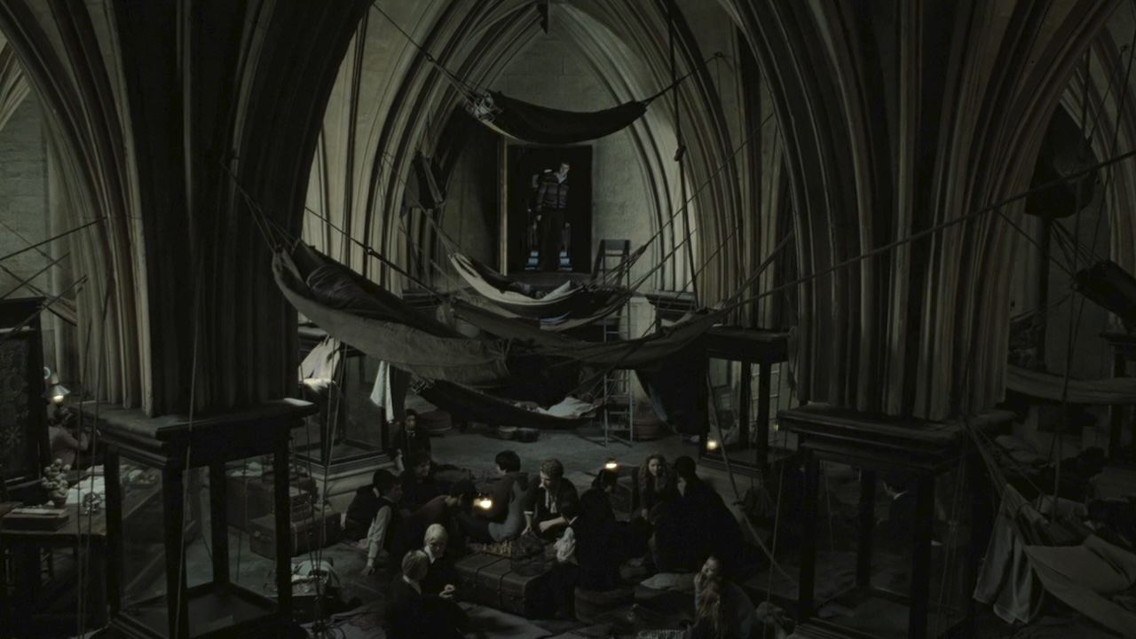 The Room of Requirement set up with hammocks, and students resting in Harry Potter and the Deathly Hallows Part 2