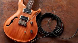 PRS with a guitar cable