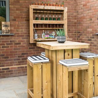 garden patio with wood bistro table and bar stools