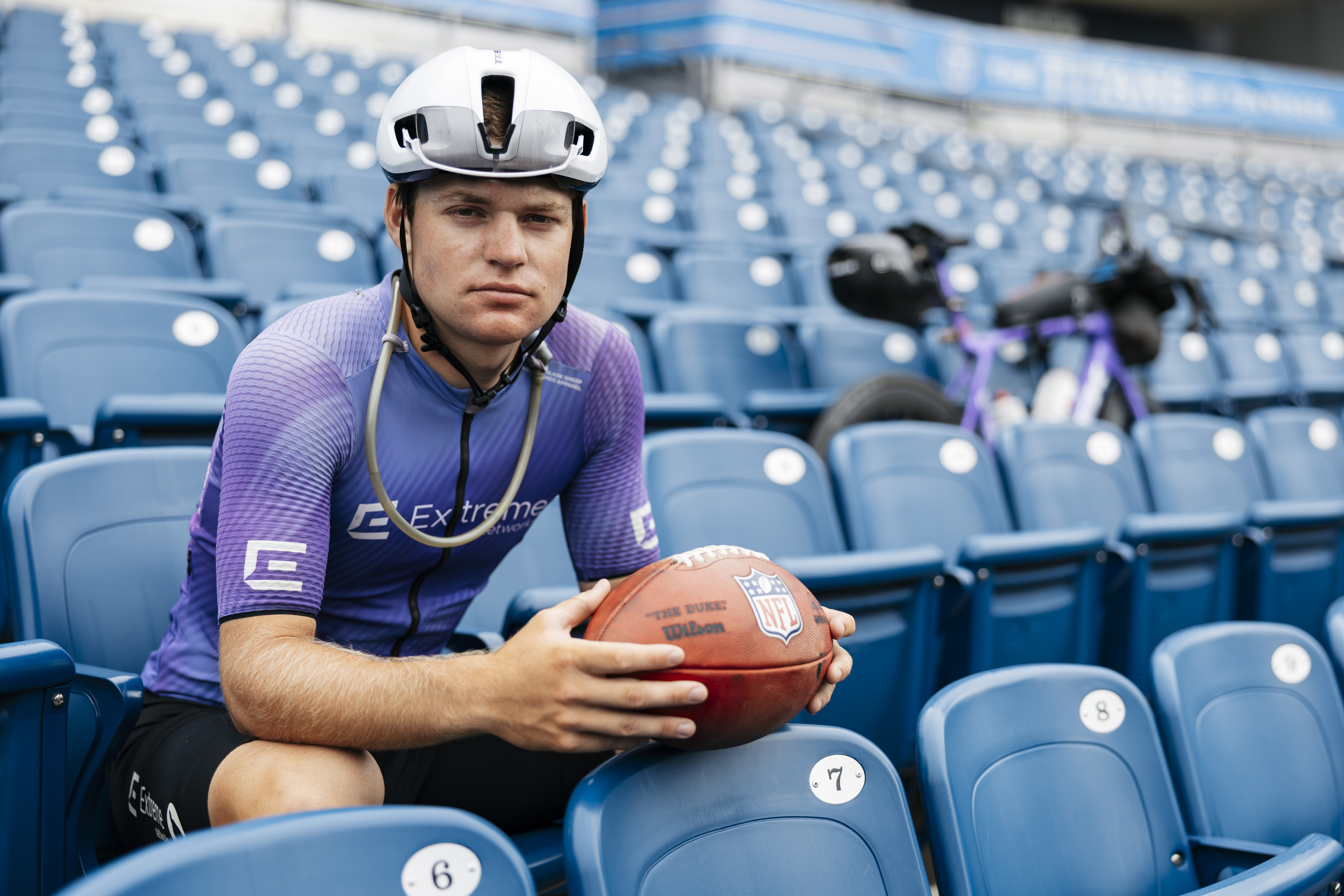 Bond Almand sitting in a stadium with bike and ball