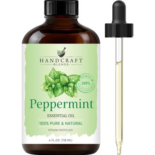 A brown bottle of peppermint oil with a green label and pipette