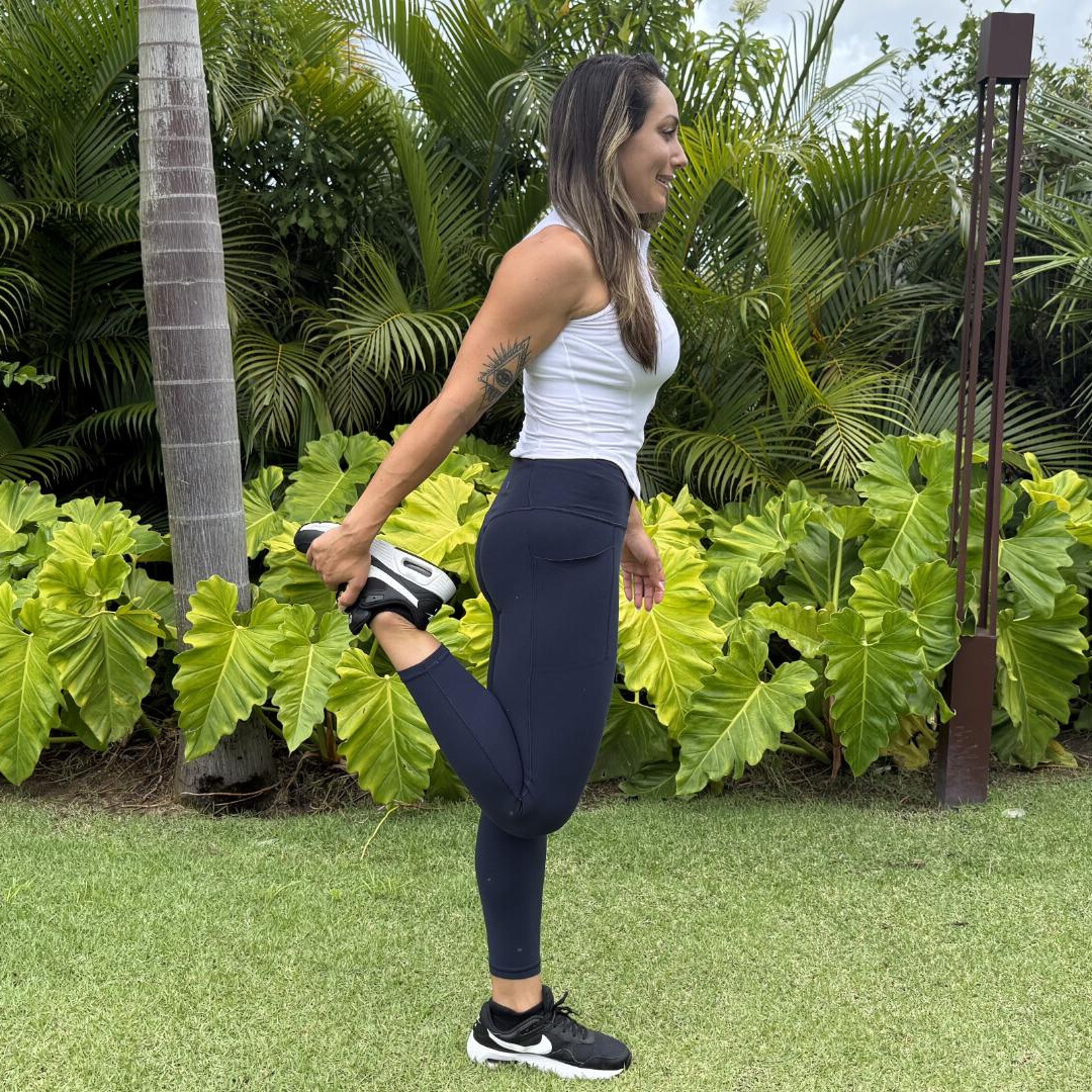Woman stretching her quad outdoors