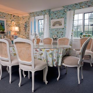dinning room with white chair and table leaf printed wall