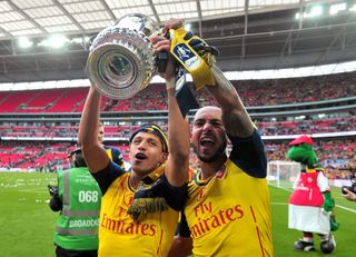 Sanchez (left) won the FA Cup twice with Arsenal
