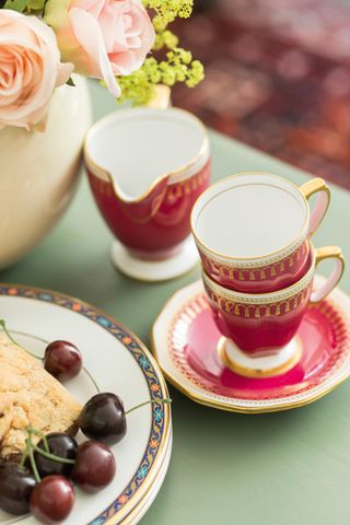 red teaset on table with scone