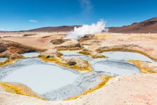 The volcanic activity of Sol de Manana in Bolivia, with mud pits and steaming fumaroles.