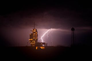 Lightning and the space shuttle Endeavour are seen at Launch Pad 39A as a storm passes by prior to the rollback of the Rotating Service Structure (RSS), Thursday, April 28, 2011, at Kennedy Space Center in Cape Canaveral, Fla.