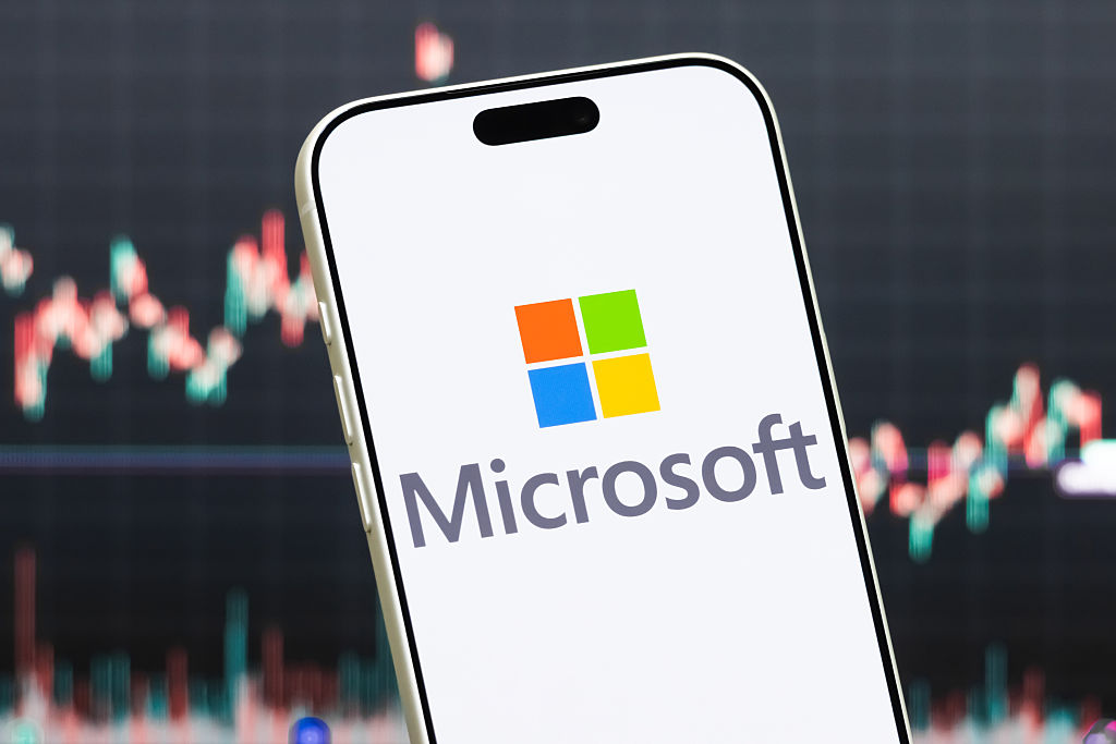 A smartphone displays the logo of Microsoft Corporation (NASDAQ: MSFT) in front of a screen showing the company&amp;rsquo;s latest stock market chart on July 23, 2026