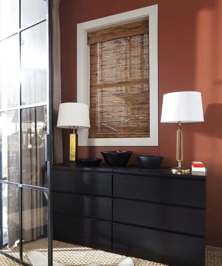 hallway decorated in warm orange with a dark wood console table
