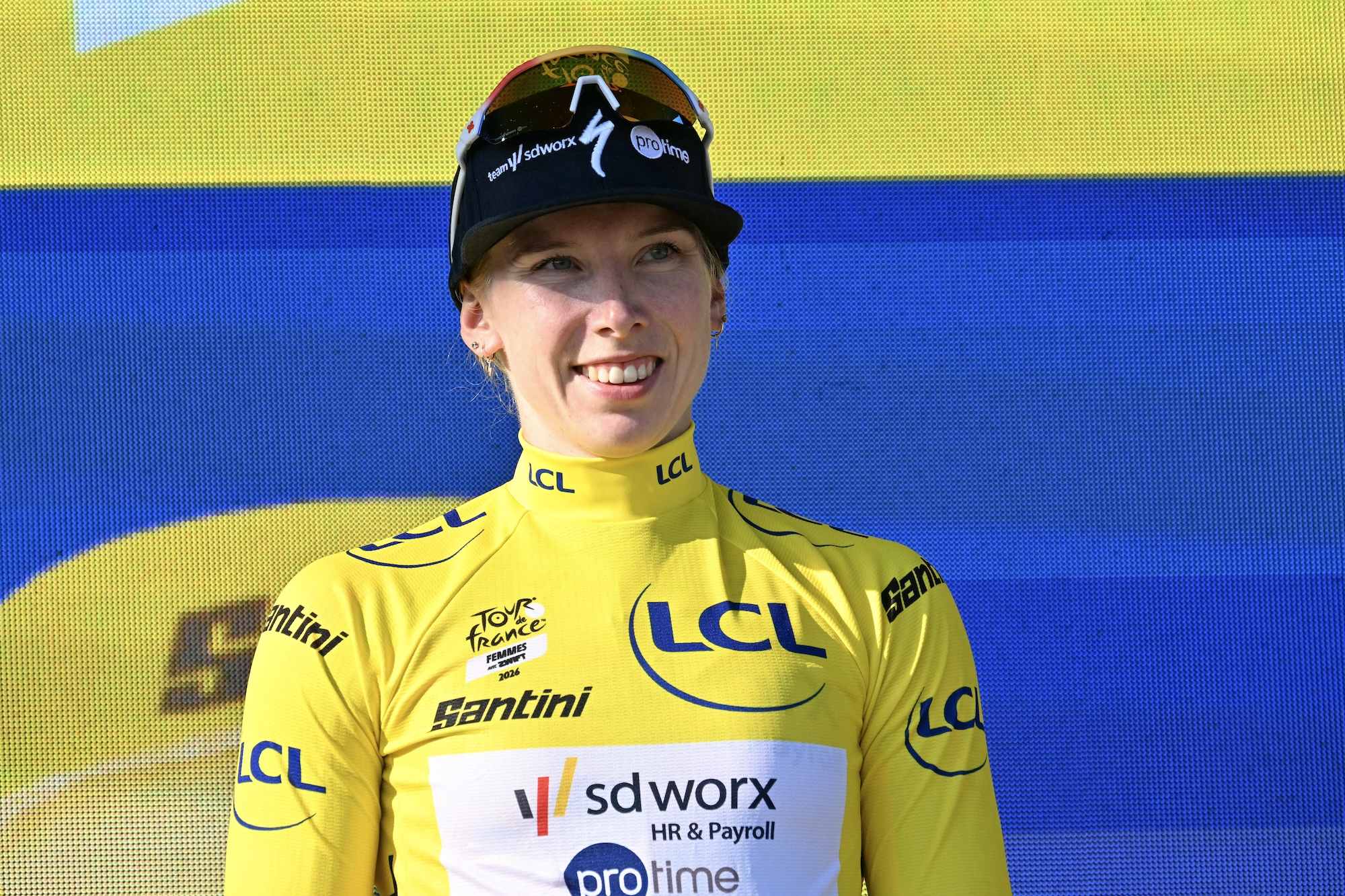 The yellow jersey of overall leader Team SD Worx-Protime's Dutch rider Lorena Wiebes poses on the podium after she won the first (out of 9) stage of the fifth edition of the Tour de France Femmes
