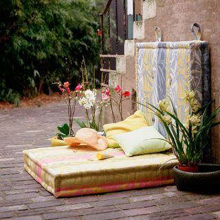 Patio with waterproof outsize floor cushion and scatter cushions