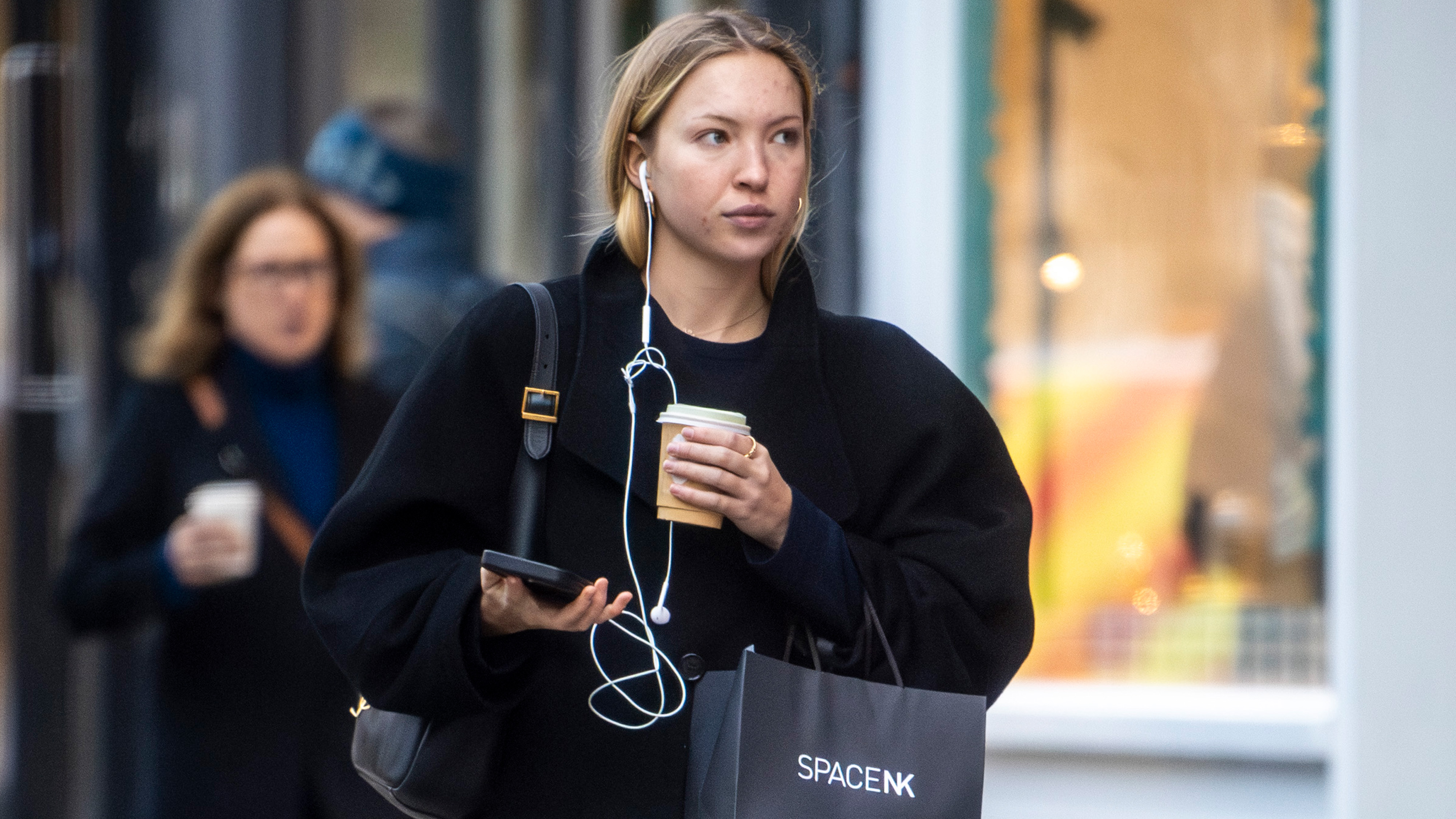 Lila Moss is seen doing some shopping in Notting Hill with a coffee. The English fashion model wore a long black coat over denim jeans and a Saint Laurent bag.
